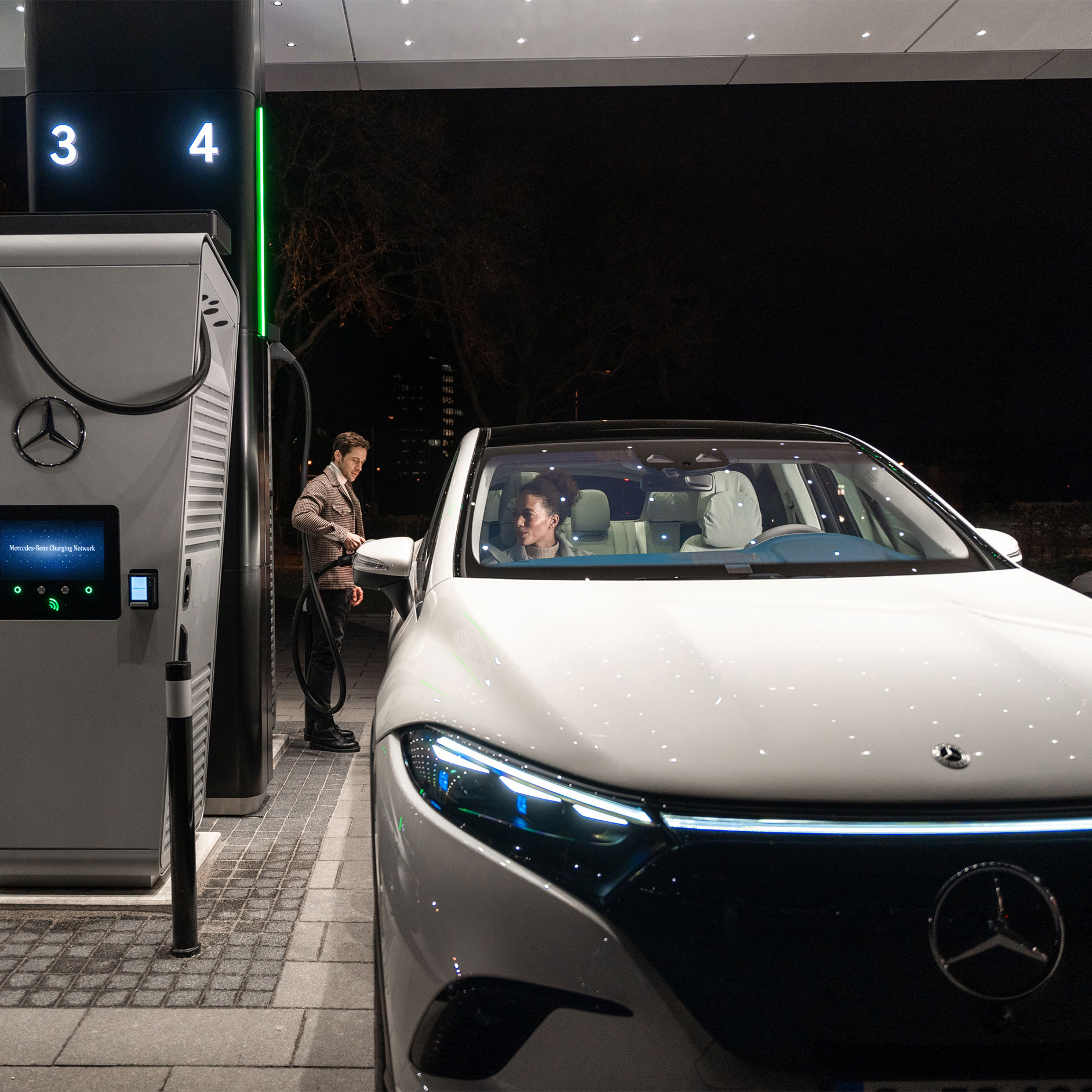 Laddningslösningar | Teknik | Mercedes-Benz Mercedes-Benz CLA står på en gata och är ansluten till en laddningsstation.